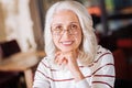 Cheerful senior woman sitting and smiling peacefully