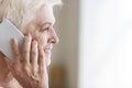 Side view of senior woman talking by phone