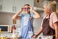 Happy grandma and lovely granddaughter having fun with cooking Royalty Free Stock Photo