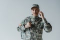 cheerful serviceman in army uniform talking