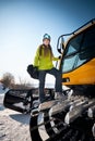 Cheerful skier girl in green jacket