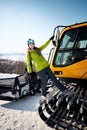 Cheerful skier girl in green jacket