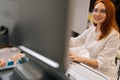 Cheerful skilled female doctor doing stomach sonography checkup using advanced modern medical equipment at medical Royalty Free Stock Photo