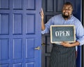 A cheerful small business owner with open sign Royalty Free Stock Photo