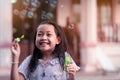 Cheerful smile little girl play with bubble blower at home Royalty Free Stock Photo
