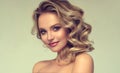 Pretty blond-haired model with curly, loose hairstyle and attractive makeup.