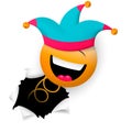 A cheerful smiling face, in a jester`s cap, suddenly breaks through the wall. Happy fools day.