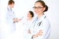 Cheerful smiling female doctor on the background with physician and his patient in the bed Royalty Free Stock Photo