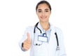 Cheerful smiling female doctor showing thumbs up, isolated over white background. Latin american or Hispanic young woman Royalty Free Stock Photo