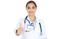 Cheerful smiling female doctor showing thumbs up, isolated over white background. Latin american or Hispanic young woman Royalty Free Stock Photo