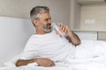 Cheerful middle aged man drinking water after waking up Royalty Free Stock Photo