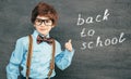 Cheerful smiling little boy against chalkboard. Looking at camera. School concept Royalty Free Stock Photo