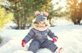 Cheerful smiling little child playing on snow in winter Royalty Free Stock Photo