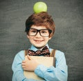 Child portraitCheerful smiling little boy against  chalkboard. Looking at camera. School concept Royalty Free Stock Photo