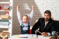 Cheerful smiling little school girl in school uniform having fun in classroom. Fun kids education. Serious teacher with Royalty Free Stock Photo