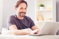 Cheerful smiling man sitting at the table