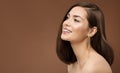 Cheerful Smiling Model Profile Side View. Brunette Beauty Woman with Nude Make up Smooth Skin and Golden Earring over Brown Royalty Free Stock Photo