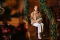 Cheerful smiling redhead young woman looking at camera happily holding gift box in hand. Royalty Free Stock Photo