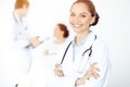 Cheerful smiling woman-doctor on the background of his patient in the bed. Medicine concept Royalty Free Stock Photo