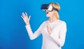 Cheerful smiling woman looking in VR glasses. Confident young woman adjusting her virtual reality headset and smiling