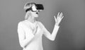 Cheerful smiling woman looking in VR glasses. Confident young woman adjusting her virtual reality headset and smiling