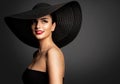 Cheerful Smiling Woman in Summer Hat. Beauty Model in Big Black Hat and Dress. Fashion Girl Face Portrait with Red Lipstick Royalty Free Stock Photo