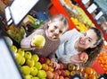 Mother and daughter buying apples . Royalty Free Stock Photo