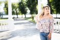 Cheerful smiling young woman on street. Beautiful fresh looking cute blonde girl outdoors. Royalty Free Stock Photo