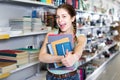 teenager buying different products in stationery shop