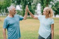 Cheerful sportsman and sportswoman giving high five and looking at each other Royalty Free Stock Photo
