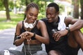 Cheerful Sporty Black Man And Woman Checking Fitness Tracker After Training Outdoors Royalty Free Stock Photo