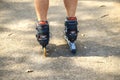 Cheerful sporty man 50-55 years old riding the roller skating in park in autumn season, rollerblading as healthy exercise for all