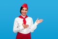 Cheerful stewardess gesturing aside during work