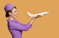 stewardess holding airplane in hand