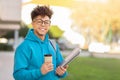 Cheerful student in blue with coffee