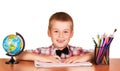 Cheerful student sitting at table, crayons and globe isolated. Royalty Free Stock Photo