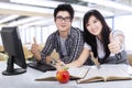 Cheerful students showing thumbs-up 1 Royalty Free Stock Photo