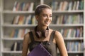 Cheerful stylish college student girl posing in campus library Royalty Free Stock Photo