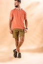 Cheerful stylish man posing in shorts and summer t-shirt