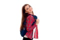 Cheerful stylish smart student girl with backpack on her shoulders posing and smiling on camera isolated on white Royalty Free Stock Photo