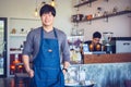 Cheerful success Asian barista! - The coffee shop startup owner standing at the coffee counter
