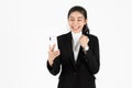 Cheerful success young Asian business woman holding mobile smart phone over white isolated background. Social network , Thinking Royalty Free Stock Photo