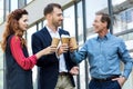 cheerful successful business team clinking with disposable cups Royalty Free Stock Photo