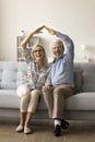 Cheerful successful senior retired couple making roof symbol Royalty Free Stock Photo