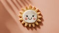 A cheerful sun-shaped cookie with a smiling face rests on a smooth, light-colored surface Royalty Free Stock Photo