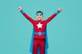 Cheerful superhero celebrating success with raised arms