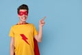 Cheerful superhero man pointing aside Royalty Free Stock Photo