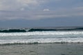 Cheerful Surfer Riding Big Foaming Ocean Wave in Sunny Nature. Man surfing on a cool surfboard in the summer sun near the idyllic Royalty Free Stock Photo