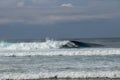 Cheerful Surfer Riding Big Foaming Ocean Wave in Sunny Nature. Man surfing on a cool surfboard in the summer sun near the idyllic Royalty Free Stock Photo