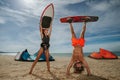 Cheerful surfing couple posing on the beach. Royalty Free Stock Photo